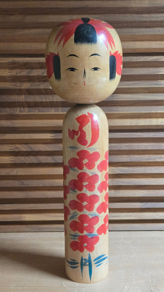 🎎 Kokeshi traditionnelle – chevelure rouge et noire, kimono à fleurs rouges et feuillage bleu-vert